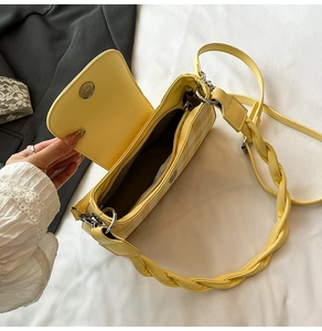 Detail of yellow checkered shoulder bag showing interior lining and braided strap