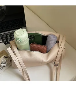 Top view of beige leather shoulder bag showing spacious interior for daily essentials