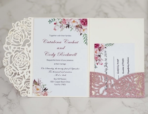 Detail of laser-cut rose wedding invitation set with glitter pocket and floral insert