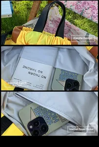 Detail view of yellow backpack showing handle, internal pockets and zipper compartment
