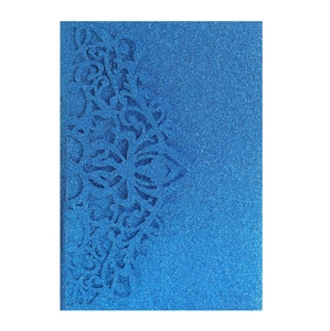 Detail of laser-cut floral pattern on navy blue glitter paper for wedding invitations