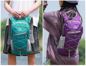 Detail view of lightweight hiking backpacks in green and purple with adjustable bungee cords
