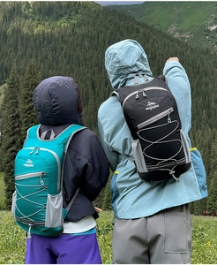 Detail view of lightweight hiking backpacks in green and black with elastic cords