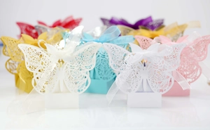 Laser-cut butterfly gift boxes in assorted colors with delicate rose patterns and ribbons