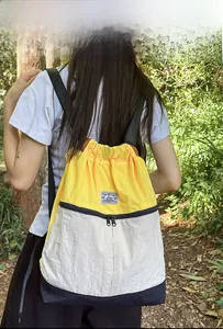 Outdoor drawstring backpack featuring tri-color stitching and durable nylon texture