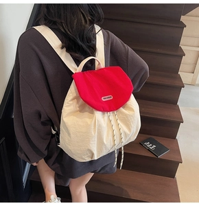Detailed back view of a stylish red and white casual backpack with drawstring closure