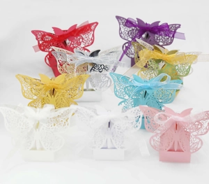 Detailed laser-cut butterfly candy boxes with satin ribbons in eight assorted colors