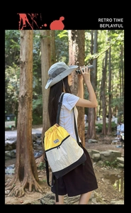 Outdoor scene showing a color-block drawstring backpack and mesh sun hat for hiking