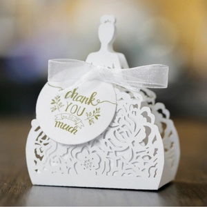 White laser-cut wedding favor box with silhouette design and thank you hang tag