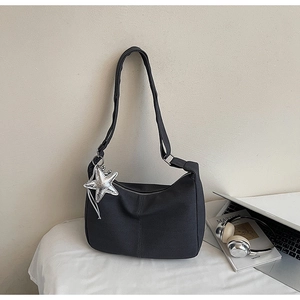 Close-up of charcoal grey crescent bag with starfish charm and adjustable canvas strap