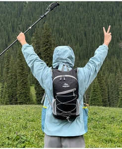 Outdoor black hiking backpack with bungee cords shown in a scenic mountain setting