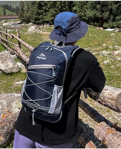 Outdoor cycling backpack featuring reflective strips and elastic cord system for hiking