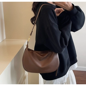 Close-up of a dark brown litchi pattern leather Hobo bag featuring a gold buckle