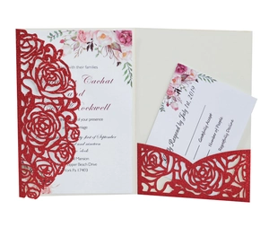 Detail of red laser-cut rose hollow wedding invitation with glitter and floral RSVP card