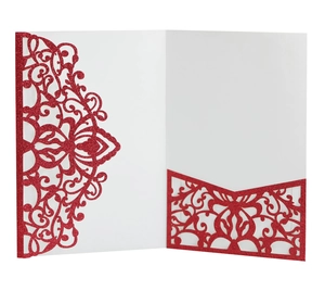 Detail of red glitter laser-cut wedding invitation with intricate lace hollow pattern