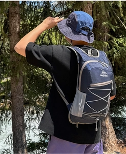 Detailed view of lightweight navy nylon outdoor backpack with elastic cords for hiking