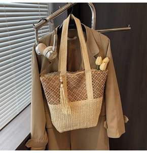 Close-up of woven tote bag featuring two-tone crochet patterns and wooden bead tassel