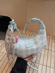 Blue and white checkered crescent handbag with knotted handle and shoulder strap