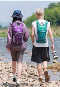 Close-up of lightweight hiking backpacks in purple and green with elastic bungee cords