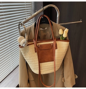Detail of woven straw tote bag texture with brown leather straps and summer vacation vibes