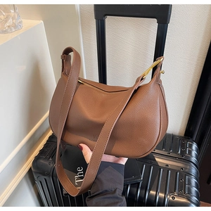 Detail of brown litchi pattern leather hobo bag with adjustable strap and zipper
