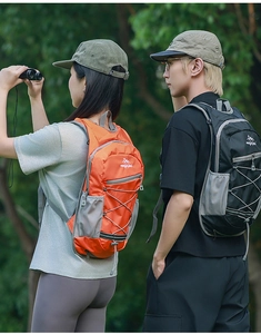 Detail of lightweight hiking backpacks in orange and black with ripstop nylon and mesh pockets