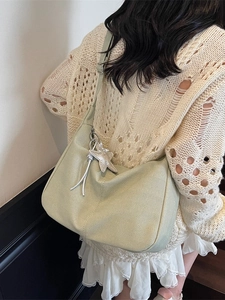 Pistachio green textured hobo bag with star charm shown on a female model