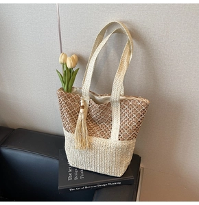 Detail of bohemian woven tote bag showing contrast textures, hollow mesh, and side tassel