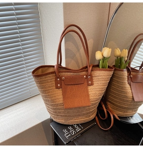 Detailed straw weave texture and brown faux leather pocket on a bohemian tote bag