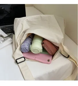 Interior view of large beige canvas tote bag showing tablet and daily essentials storage