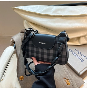 Detail of checkered shoulder bag featuring black woven rope handle and brand lettering
