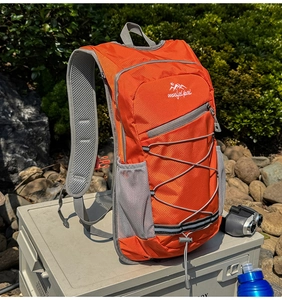 Close-up of bright orange outdoor hiking backpack with breathable mesh shoulder straps