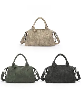 Three vintage crossbody bags in grey, green, and black with textured finish on white background