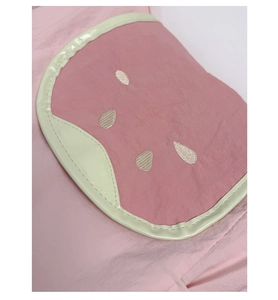 Close-up of pink tote bag detail with cute watermelon-shaped embroidered patch pocket