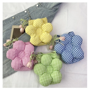 Detail of flower-shaped gingham handbags featuring pearl handles and tulip pendants