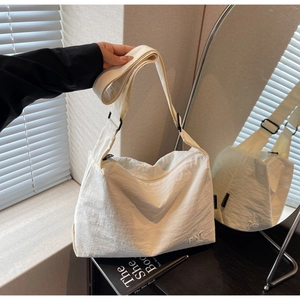 Détail du grand sac cabas blanc cassé avec texture froissée et boucle noire réglable