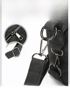 Detailed close-up of gunmetal hardware and durable zipper on black crossbody bag