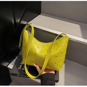 Detail shot of lime green铆钉 bag showing polished silver studs and smooth zipper