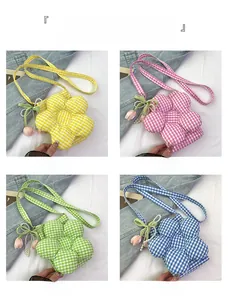 Detail of four colorful plaid flower-shaped crossbody bags with tulip and pearl charms
