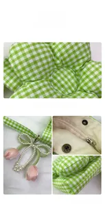 Detail view of plaid flower bag showing pearl bow and pink tulip charm with metal zipper