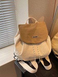 Fashionable dual-tone backpack for women featuring cream body and khaki flap design