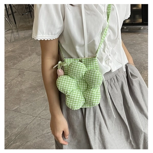 Detail view of floral crossbody bag with green vichy plaid and pearl tulip charm