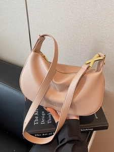 Minimalist crossbody crescent dumpling bag in nude leather with gold hardware