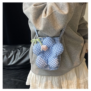Detail of flower-shaped checkered canvas crossbody bag with pearl charms and strap