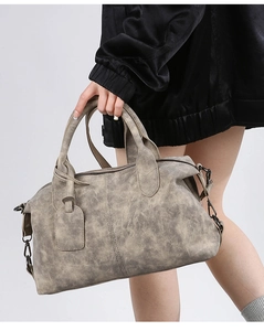 Detail of vintage Boston bag in taupe faux leather with reinforced handles and metal hooks