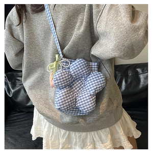 Detailed shot of a blue checkered flower-shaped crossbody bag with pearl strap