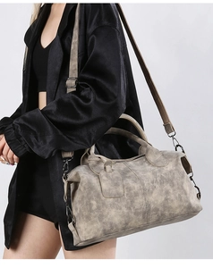 Detailed side view of vintage grey Boston bag with textured leather and metal strap hook