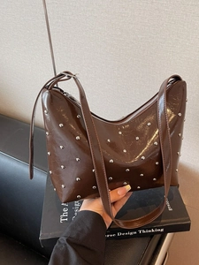Large dark brown rivet shoulder bag with glossy finish in a stylish dumpling hobo design