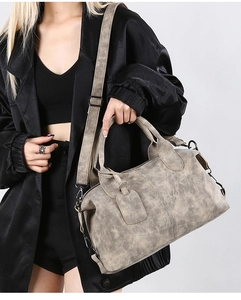 Macro view of vintage style faux leather satchel with weathered texture and top handles