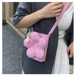 Pink checkered crossbody bag with 3D flower and tulip charm shown on a model